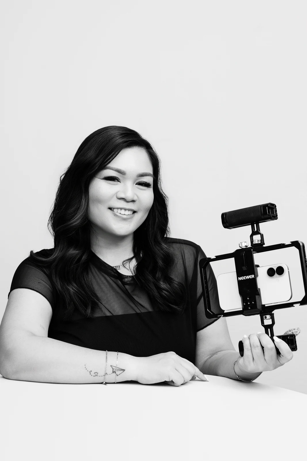 Kat smiling while holding her mobile filming rig