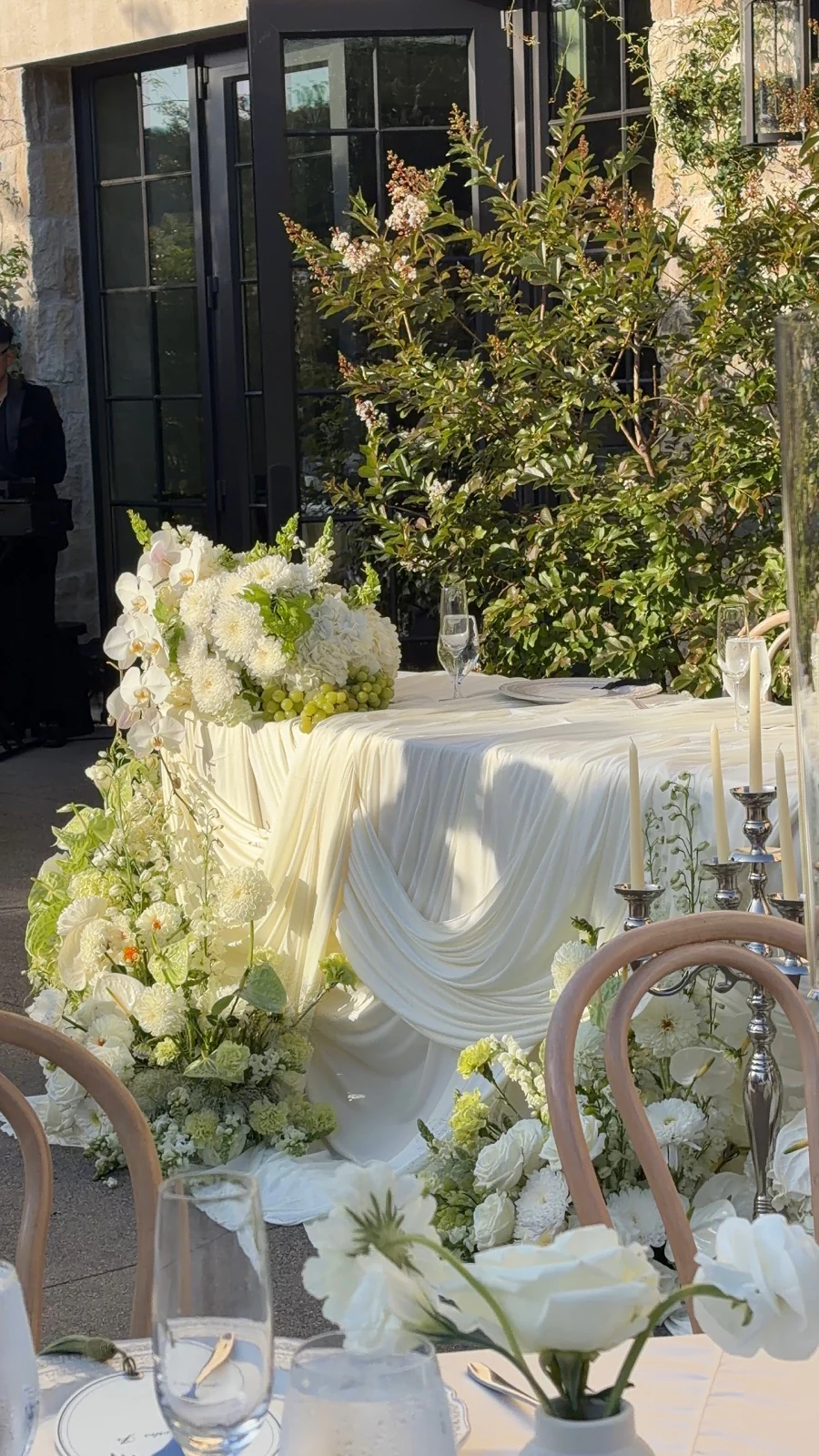Elegant outdoor wedding reception table with white flowers